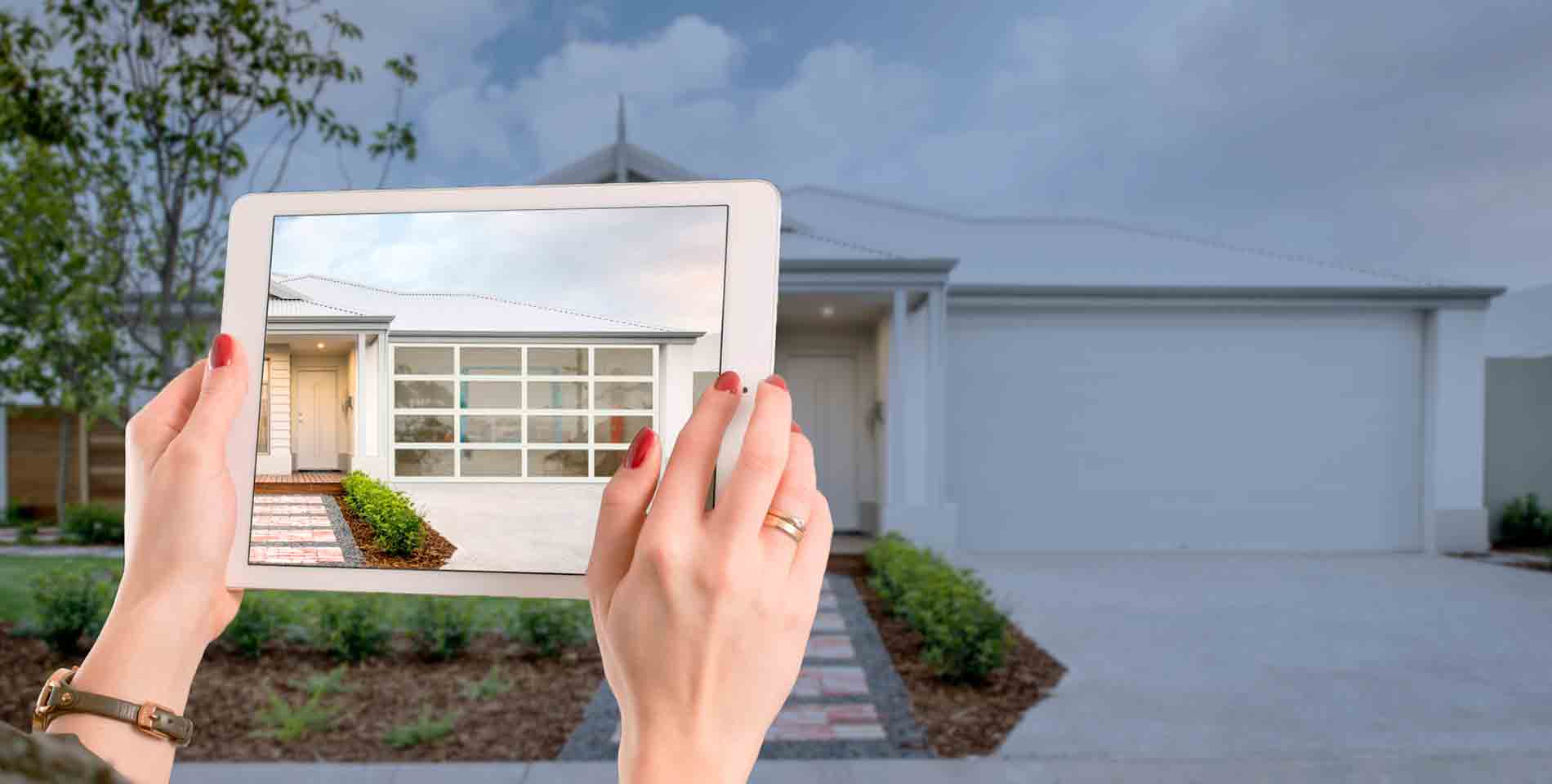 Tablet with Centurion Garage Door Visualiser tool on it in front of a house showing garage door