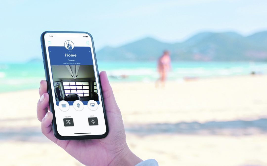 Woman's hand holding a smartphone with the Centurion Garage Door App on it at the beach