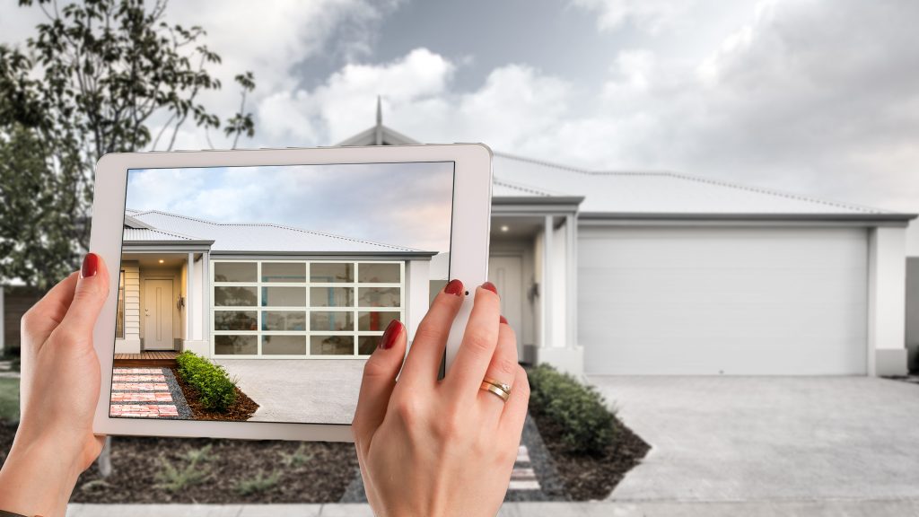 Centurion Garage Doors visualiser tool open on a tablet in front of a house with a white garage door